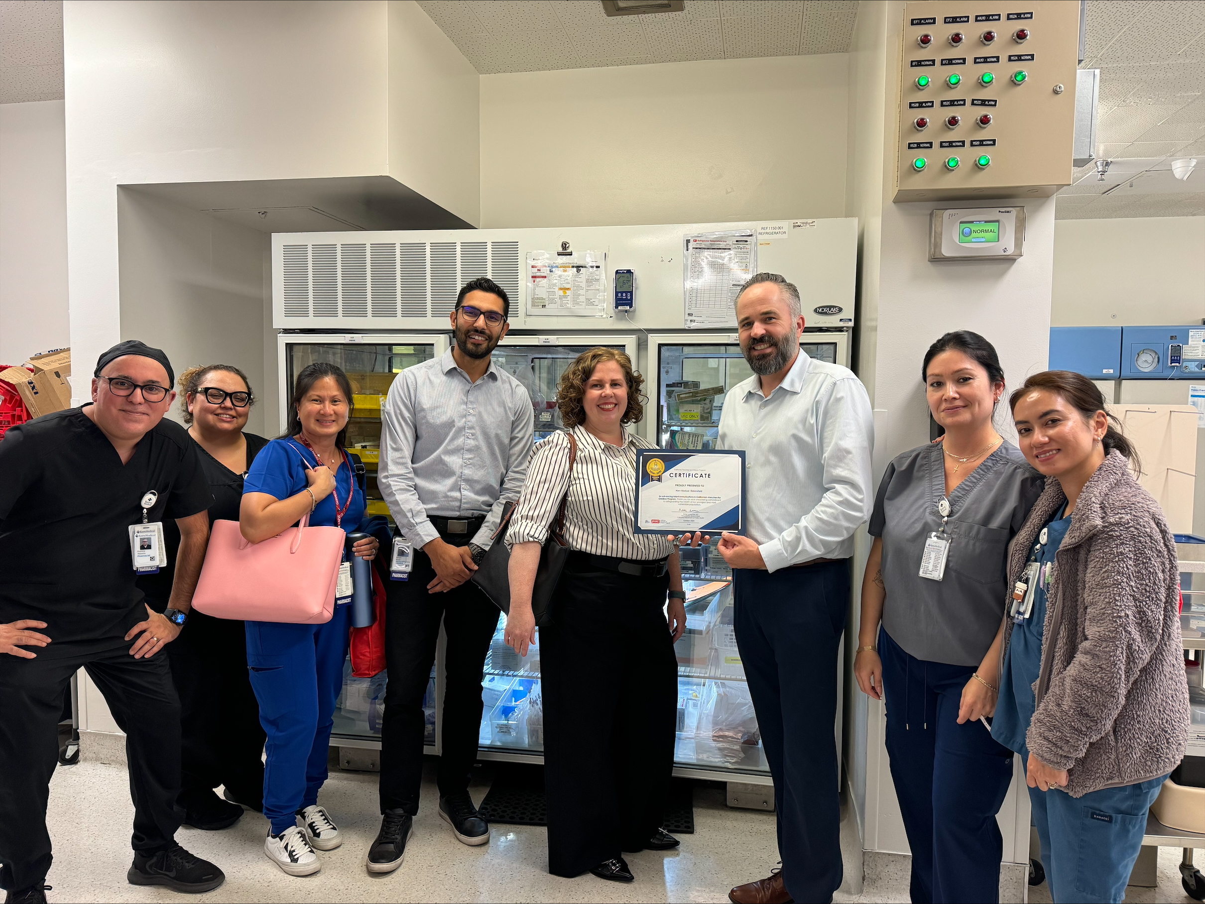 8 clinic staff holding award